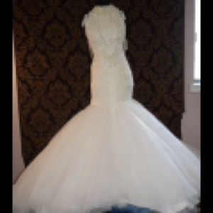 Couture runway style wedding gown with veil is on off white color dress